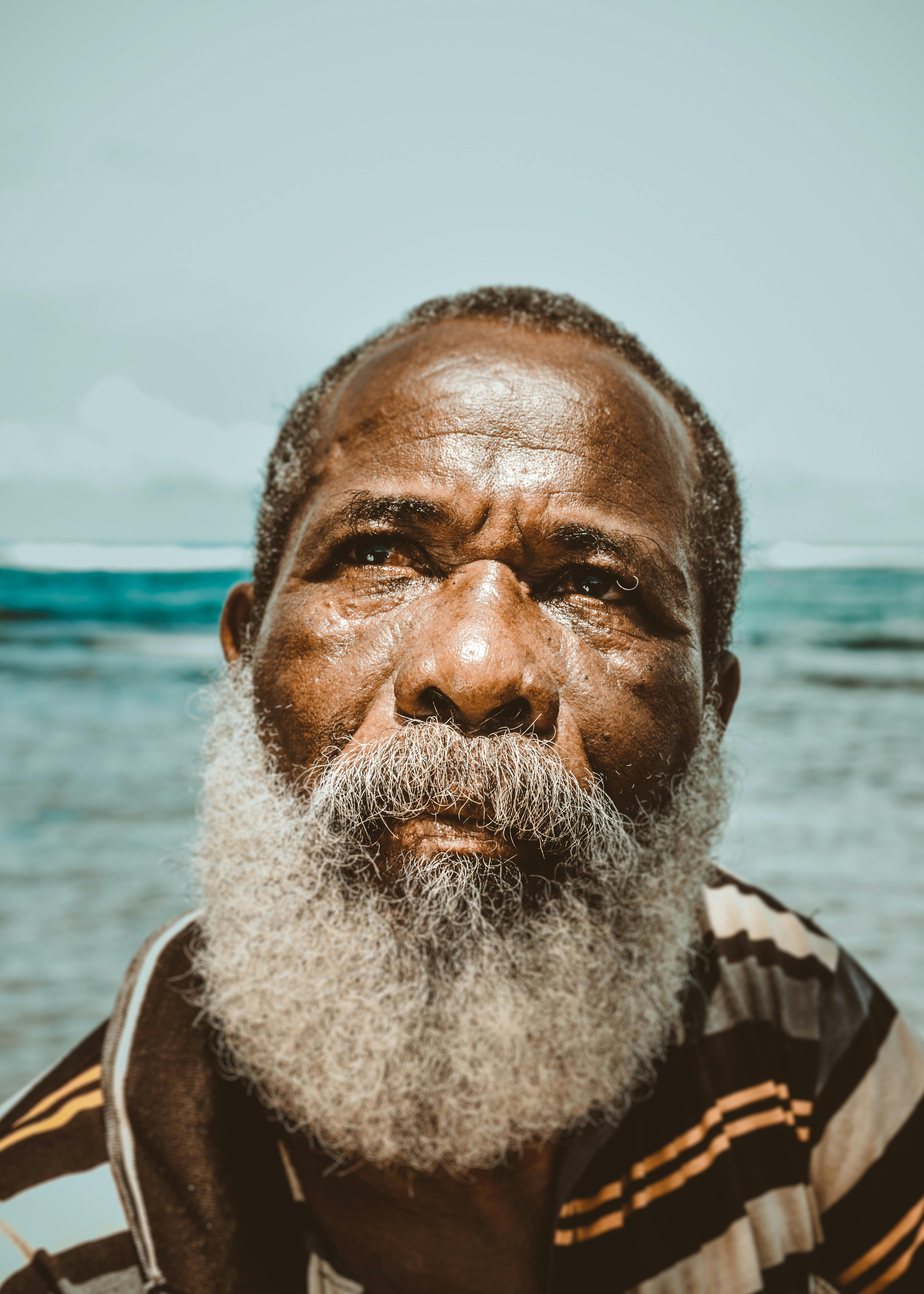 Older Black man looking deep in thought.